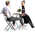 An elegant young couple sitting at the table drinking wine - person png - miniature