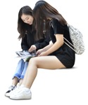 Teenager reading a newspaper sitting  (6488) - miniature