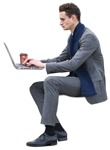Man sitting with coffee working on a laptop business person png - miniature