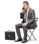 Businessman with a smartphone sitting  (13436) - miniature