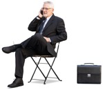 Businessman with a smartphone sitting  (12570) - miniature