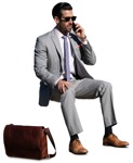 Businessman with a smartphone sitting cut out pictures (14579) - miniature