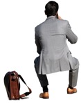 Businessman with a smartphone sitting cut out pictures (14871) - miniature