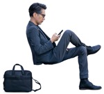 Businessman with a smartphone sitting  (14980) - miniature