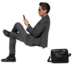 Businessman with a smartphone sitting  (15259) - miniature