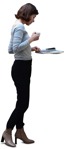 Woman reading a newspaper standing  (6493) - miniature