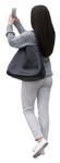 Woman with a smartphone standing people cutouts (11285) | MrCutout.com - miniature
